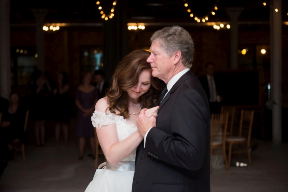 Bride dancing with her dad during father-and-daughter dance at a wedding.